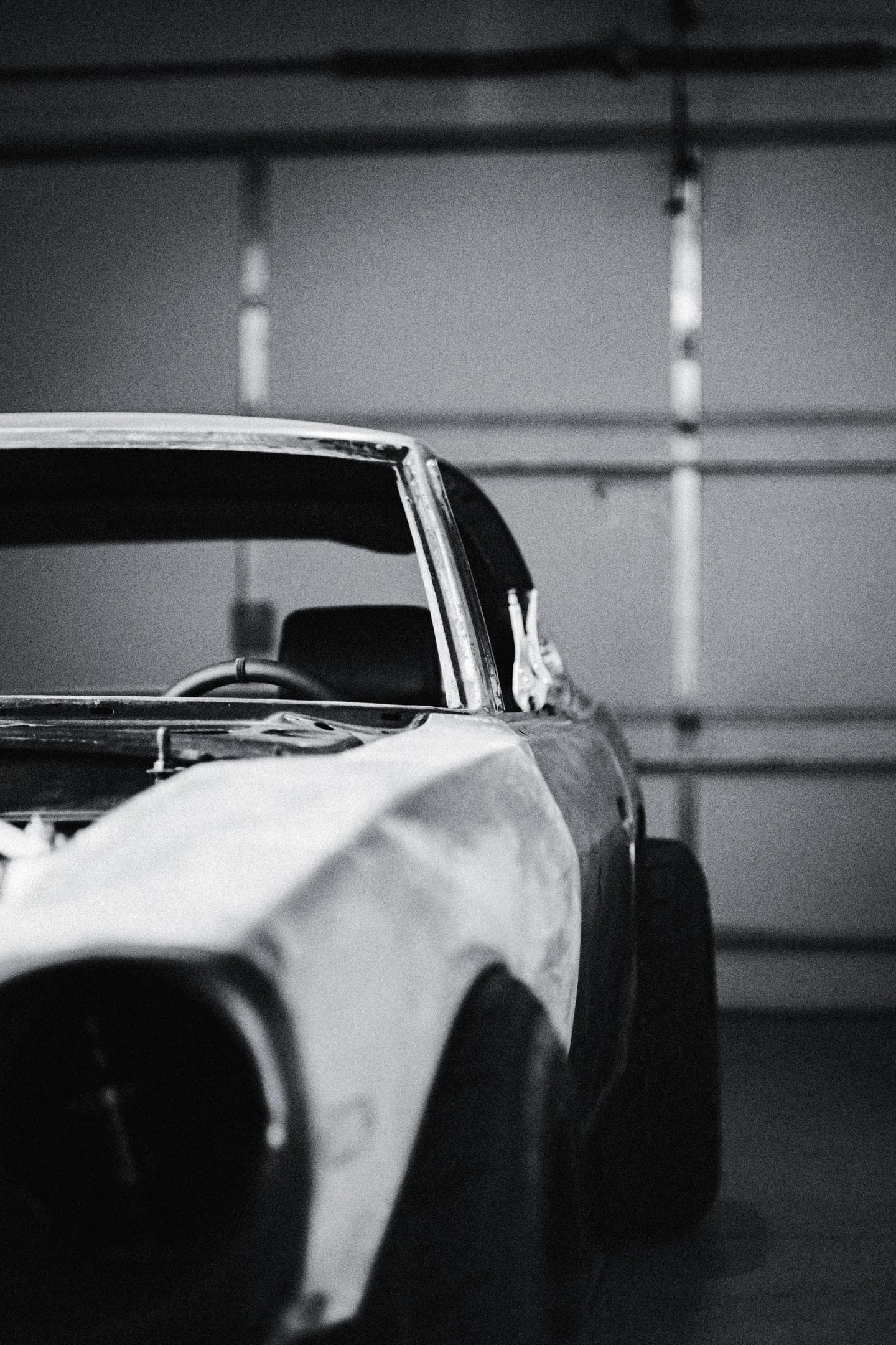 Front-quarter detail of the bare-metal Datsun 280Z